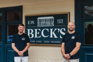 New owners Dan Feehan and Brian Wilbur pose in front their restaurant, E.W. Beck's, in Sykesville during Economic Development Week visits.