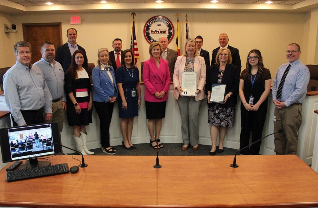 Image of large group of people accepting proclamation from the Carroll County Commissioners