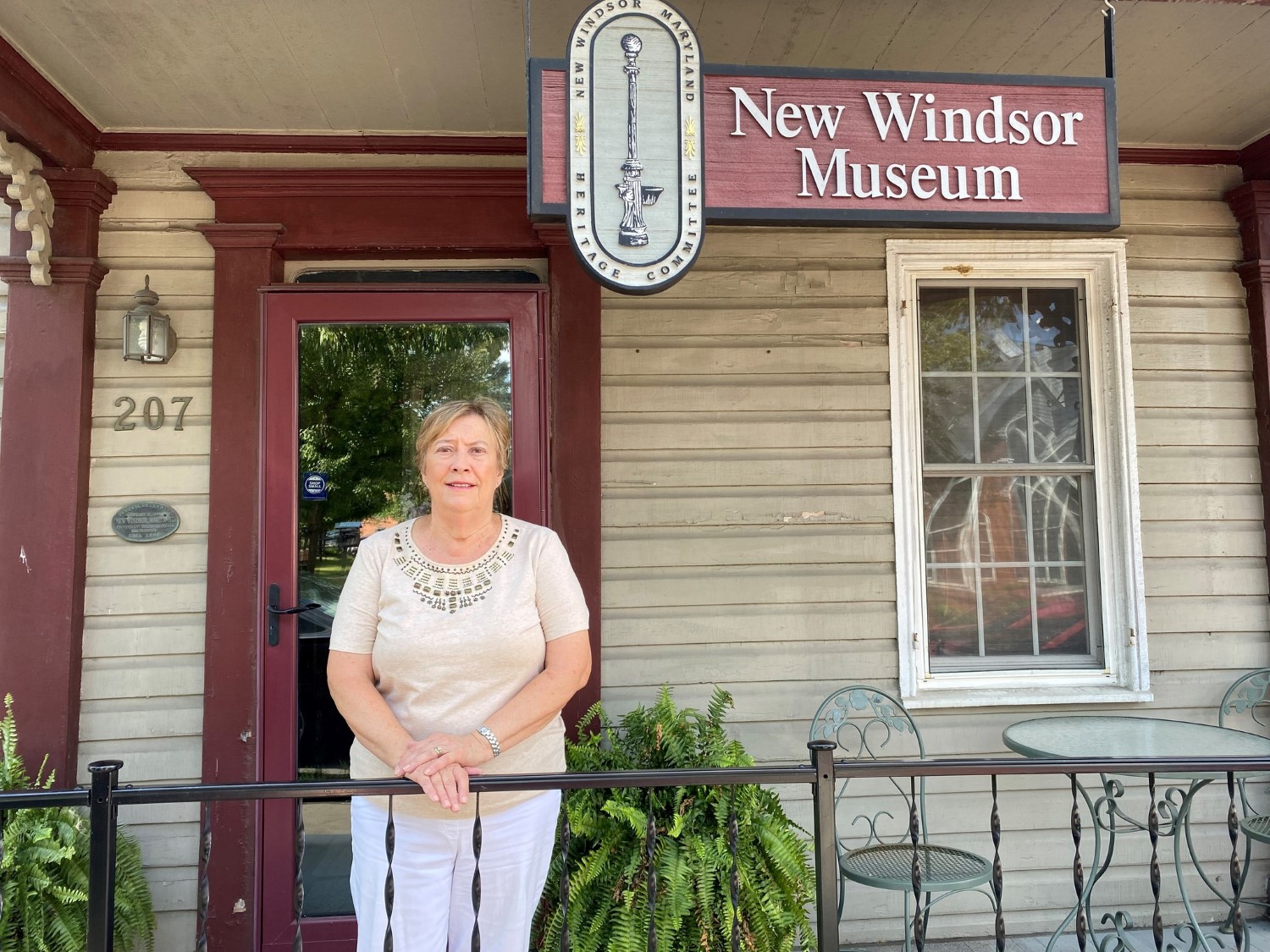 Linda Selby, President of New Windsor Heritage, standing in front of the museum