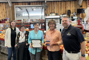 Image of staff and Baugher's staff receiving the pillars award