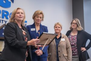 Denise Beaver, Director, Carroll County Economic Development, Darren Peyton, Regional Director, Small Business Development Center, and Jacob Fernandez, with Carroll County Workforce Development., present an award to Dr. Rosalie Mince, along with Kelly Koermer, and Kristie Crumley. Credit: Photo by Andrew Mangum for Carroll Community College.