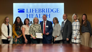 Image of Garrett Hoover, President and team presented with the Pillar Award by the Econ Dev representatives.