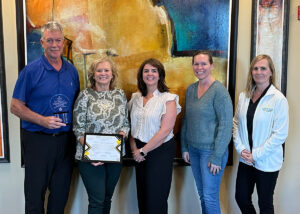 Image of Lenny Mills, VP & COO, Denise Beaver, Dir. Econ Dev, Amy Wallace, SBDC, Angela Reed, Accounting Manager and Alisa Geffert, Econ Dev with the Pillar Award and certificate.