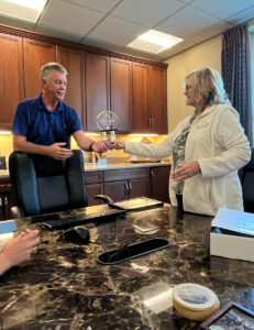 Image of Denise Beaver presenting Lenny Mills, VP & COO with the Pillar Award.
