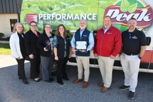 Image of Performance Foodservice president, Mike Gershenfeld and staff while Econ Dev representatives present their Pillar Award