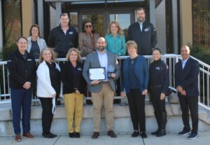 Northrop's Joshua Weinberger, Sr. Director, Power & Control Systems poses with the Econ Dev team and Commissioner Susan Krebs and more of the Northrop team.
