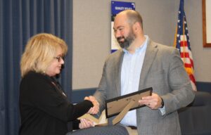 Paige Sunderland, Dep. Director, Econ Dev. Presents Joshua Weinberger, Sr. Director, Power & Control Systems & Sykesville Site Executive, Northrop Grumman with the pillar certificate.