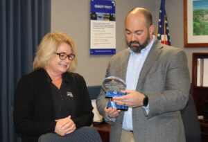Paige Sunderland, Dep. Director, Econ Dev. Presents Joshua Weinberger, Sr. Director, Power & Control Systems & Sykesville Site Executive, Northrop Grumman with the pillar award.