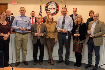Image of a group of people holding an award